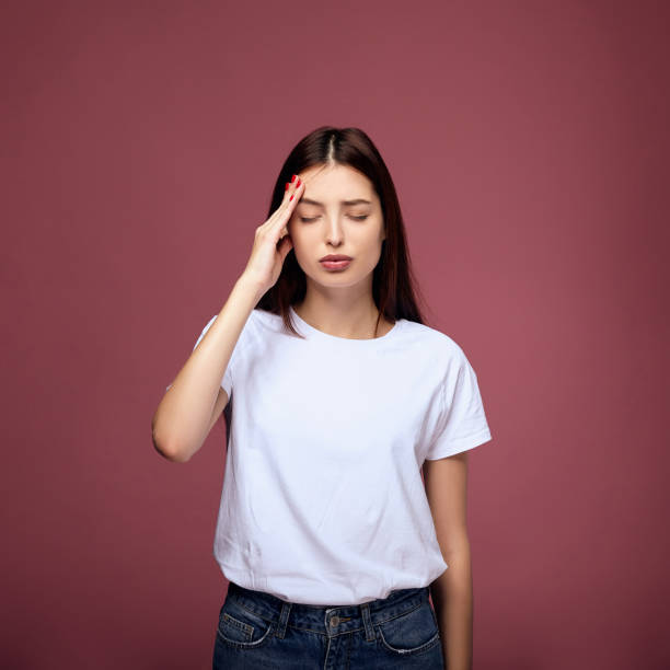 istock A young woman suffers from a headache. 1214061604