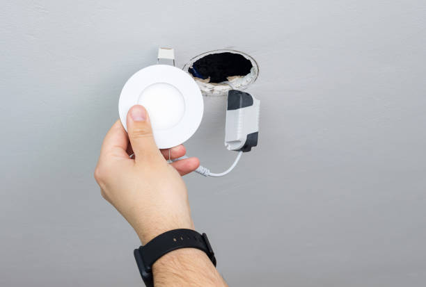 istock A man repairs a modern energy-saving LED lamp in the ceiling. 1214062175