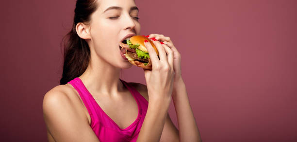 istock Gorgeous girl eating cheeseburger. 1214063184