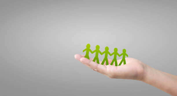 istock Human shape in paper cut with hand by hand or shake hand in hand 1214063846