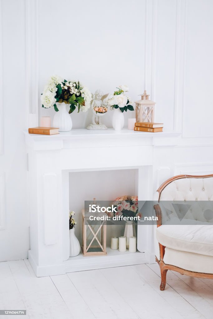 Slow living lifestyle concept. White living room with fireplace. Artificial Stock Photo