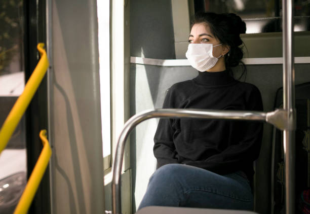istock Bus transportation protective face mask woman 1214065888