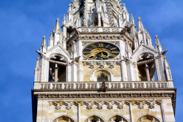 Zgreb Cathedral stone tower detail with blue sky white stone church tower & clock. stone balustrade. ornate carved decorative element at Kaptol hill in downtown Zagreb. old architecture. famous Croatian landmark. travel concept. recent earthquake damaged tower zagreb earthquake stock pictures, royalty-free photos & images