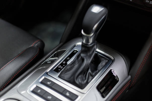 istock Selector automatic transmission with leather in the interior of a modern expensive car. The background is blurred. Black leather car interior. Luxurious car instrument cluster. Close up shot 1214067359