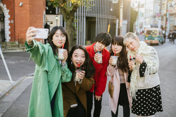 Group picture of friends enjoying bubble tea. Happy young people having good time, drinking bubble tea in Harajuku, Tokyo. tokyo harajuku stock pictures, royalty-free photos & images
