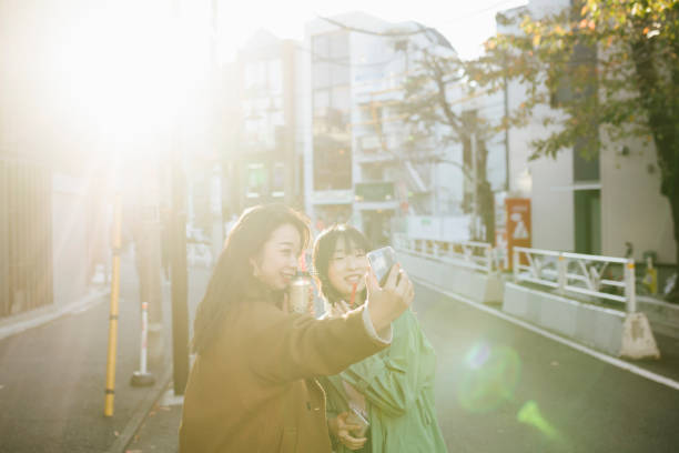 istock Two Asian Girls Taking a Selfie 1214067651