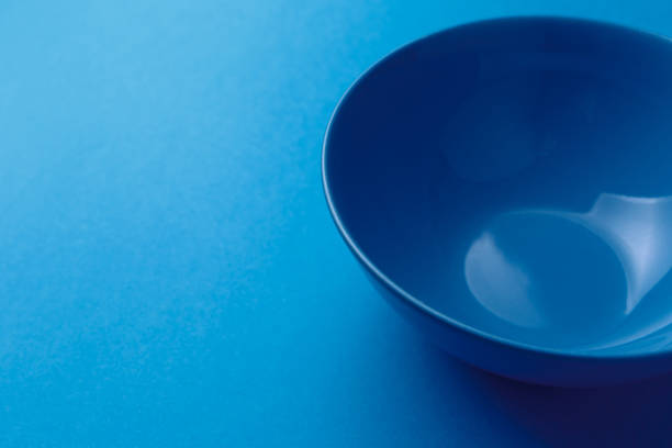istock Empty ceramic blue round plate on classic blue background. Top view. Flat lay. Copy space. Minimal creative concept. Trendy color 1214067786