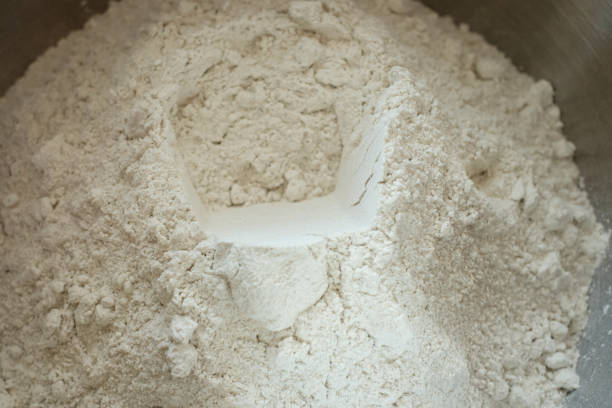 istock Heap of flour with hole close-up macro 1214069009