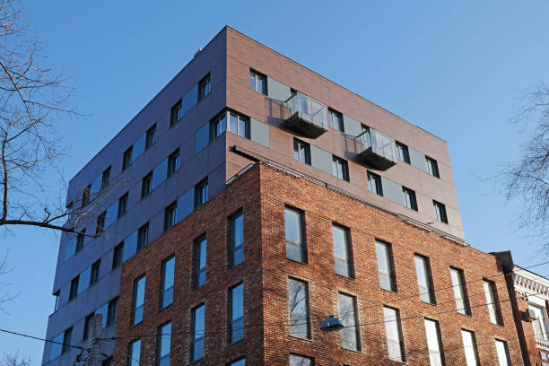 istock Brown brick building with windows and balconies bottom view. 1214069208