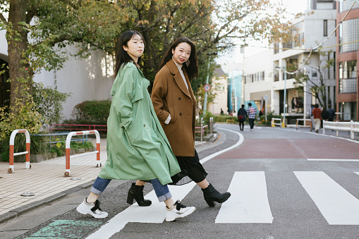 Two fashionable women crossing the street in Harajuku, Japan.