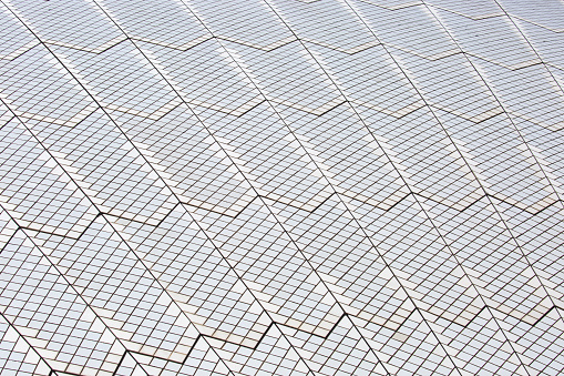 Detail of the roof of the Sydney Opera House which is covered with over 1,000,000 glazed tiles in a chevron pattern.