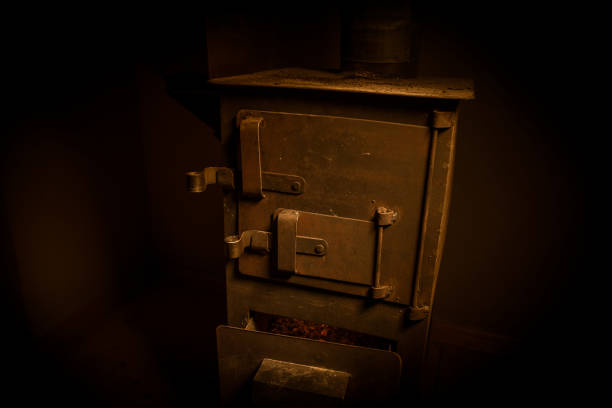 istock Fire burning in small black iron stove. Closeup photo with selective focus 1214071263