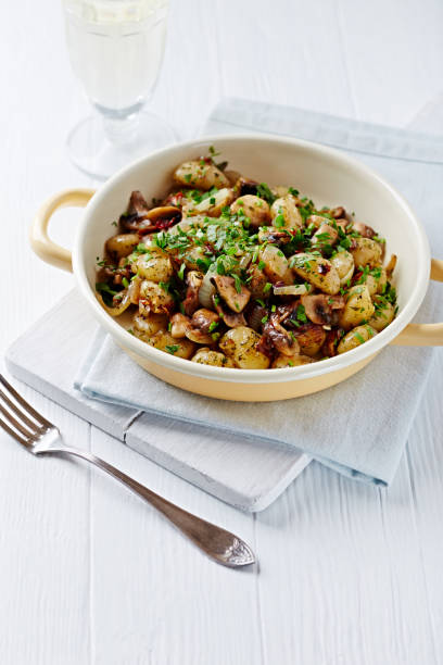 istock Gnocchi with onion and mushrooms. Bright wooden background. Copy space. 1214072482