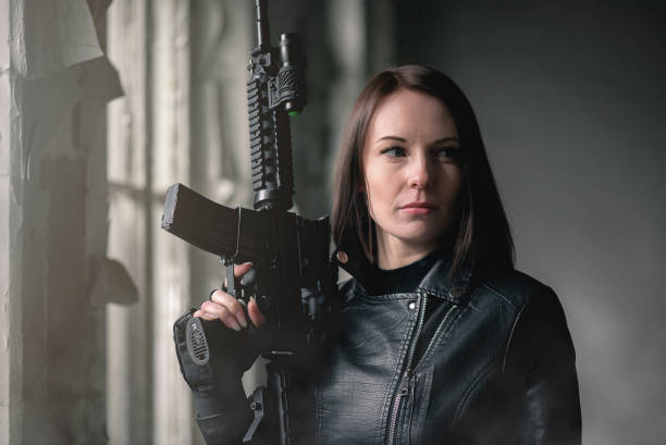 istock Woman with airsoft rifle. 1214073723