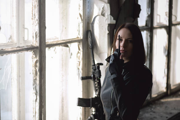 istock Woman with airsoft rifle. 1214073742