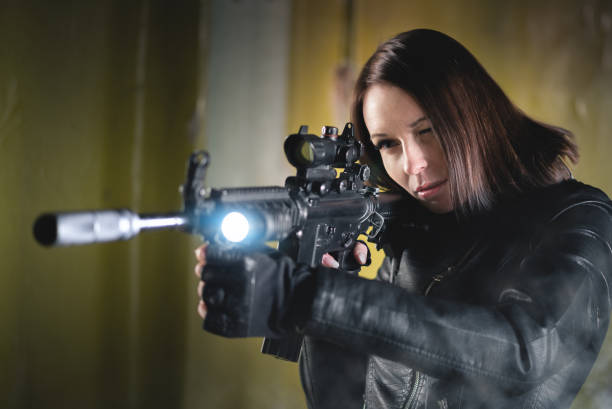 istock Woman with airsoft rifle. 1214073767