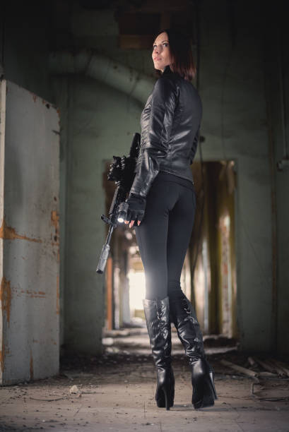 istock Woman with airsoft rifle. 1214073795