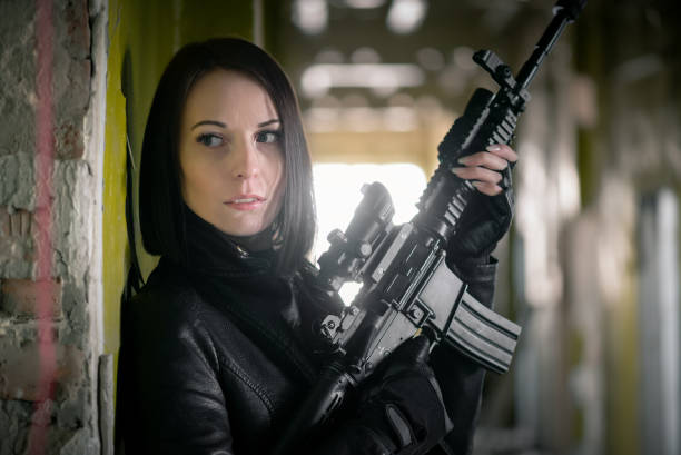 istock Woman with airsoft rifle. 1214073808