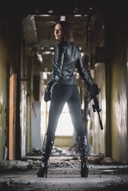 istock Woman with airsoft rifle. 1214073817