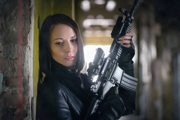 istock Woman with airsoft rifle. 1214073825