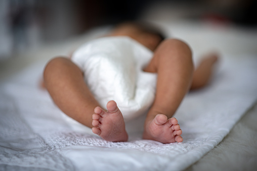 The baby is sleeping on a soft mattress