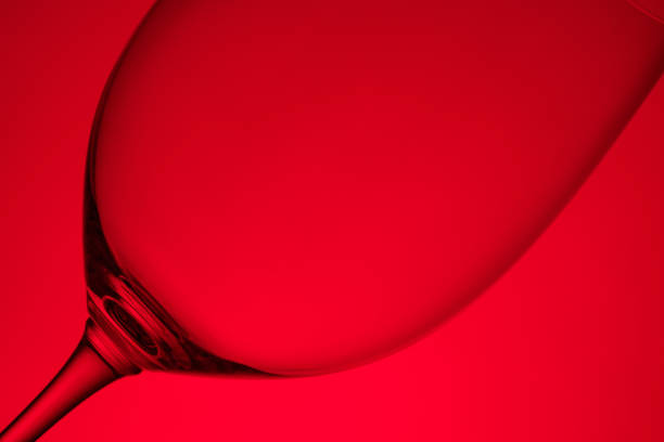 Red wine glass close-up in back lit close-up