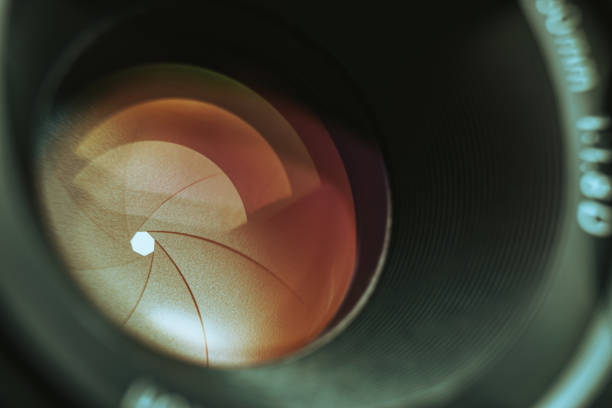 istock Beautiful camera lens with orange  light of glass. Background pattern for design. 1214076028