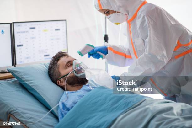 Infected Patient In Quarantine Lying In Bed In Hospital Coronavirus Concept Stock Photo - Download Image Now