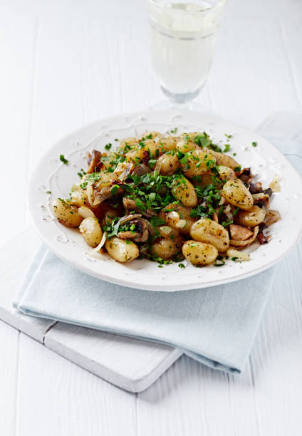 istock Gnocchi with onion and mushrooms. Bright wooden background. Copy space. 1214077746