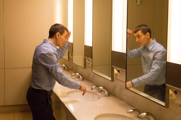 istock A man tidies his hair on his head. 1214078302