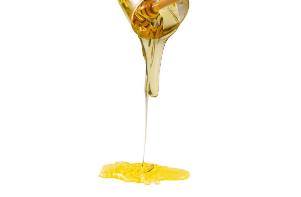 istock Dipper with honey on a white background. 1214078330