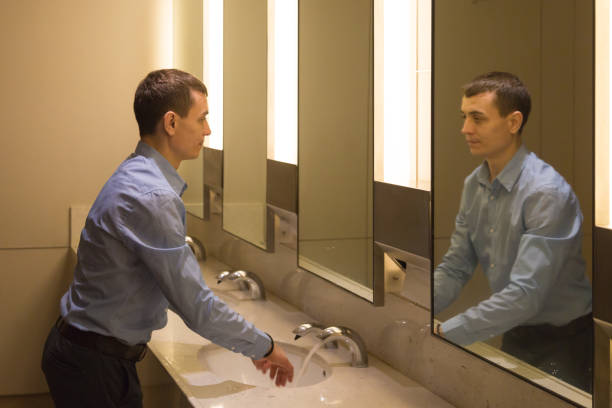 istock A man washes his hands in a public toilet. 1214078353