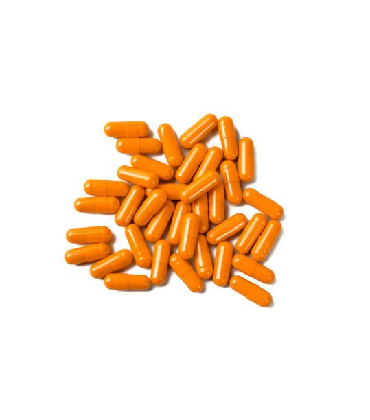 istock Orange pill capsules isolated on white background 1214081776