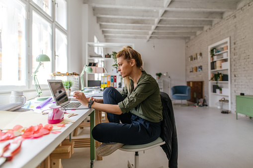 Photo of a woman working online from home office