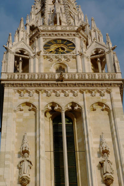 Zagreb Cathedral closeup of stone tower detail with blue sky the Zagreb cathedral's white stone church tower and clock close-up detail. ornate stone balustrade. carved decorative element at Kaptol hill. old architecture. famous Croatian landmark. travel concept. recent, 2020 March 21 earthquake damaged the tower zagreb earthquake stock pictures, royalty-free photos & images