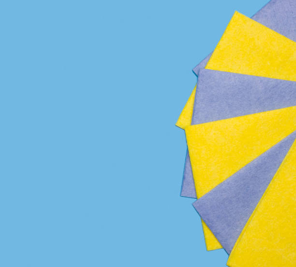 istock Yellow and blue square rags for cleaning, dusting on a blue background. Free space for text. Flat lay. 1214083147