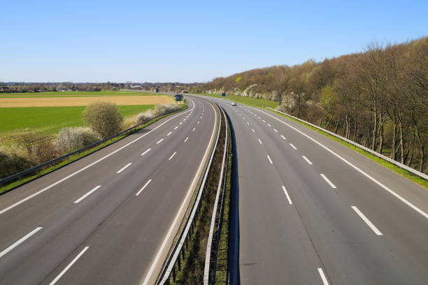 corona virus crisis stay at home and curfew concept: no traffic on deserted empty german highway a61 between germany and netherlands - german countryside imagens e fotografias de stock