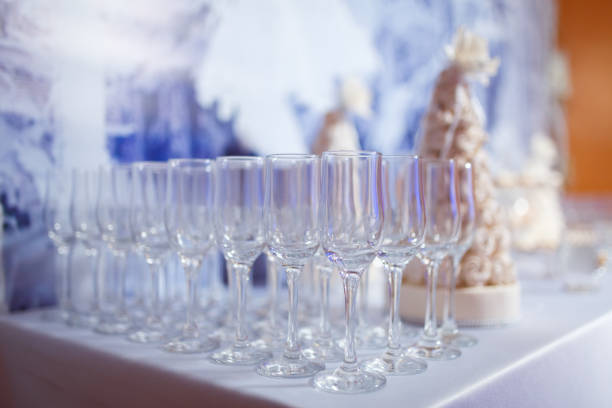 Empty glasses for wine and champagne in a row at the banquet table