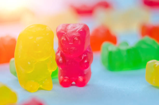 istock Two marmalade bears stand among other marmalade bears on a blue background, macro 1214087467