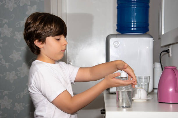 istock Child passing alcohol gel on his hands 1214089664