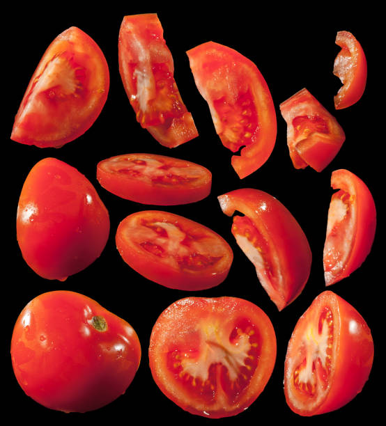 istock Red tomato isolated on black background. Workpiece for design. Salad vegetables closeup. 1214090691
