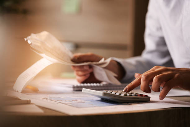 istock Close-up of business accountant using calculator while working in the office. 1214091374