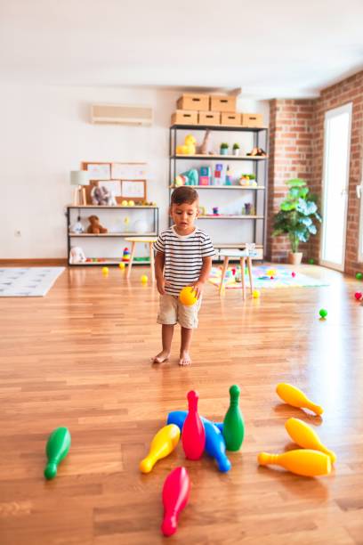 istock Beautiful toddler boy playing bowling at kindergarten 1214092107