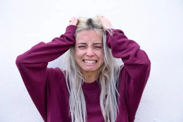 Photo of Blond young woman crying and depressive