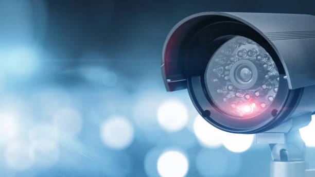 istock Close up of CCTV camera over defocused urban background 1214093147