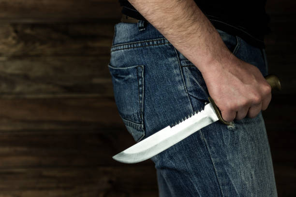istock man stands menacingly with a knife, close-up 1214093743