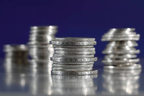 Many Euro coins stacked on white background, closeup