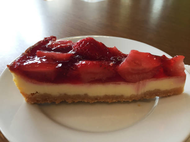istock Slice of cheesecake with strawberries on a white plate. 1214094466