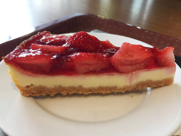 istock Slice of cheesecake with strawberries on a white plate. 1214094467