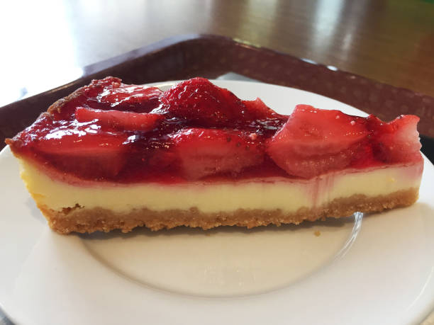 istock Slice of cheesecake with strawberries on a white plate. 1214094767